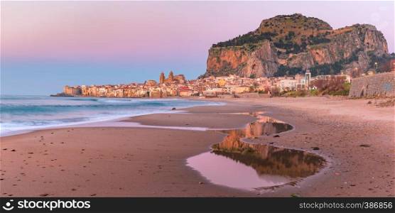 Beautiful panoramic view of the beach, Cefalu Cathedral and old town of coastal city Cefalu at pink sunset, Sicily, Italy. Cefalu at sunset, Sicily, Italy