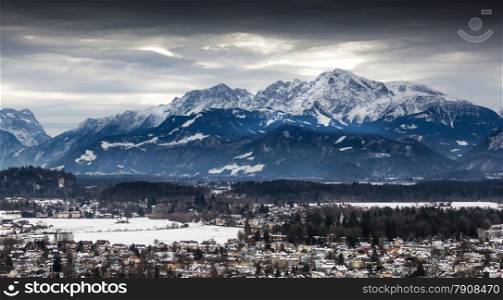 Beautiful panoramic view on Austrian Alps covered by snow at cloudy day