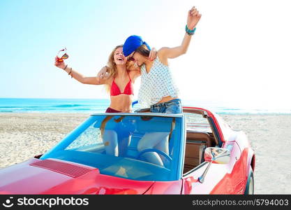 Beautiful party friend girls dancing in a car on the beach happy