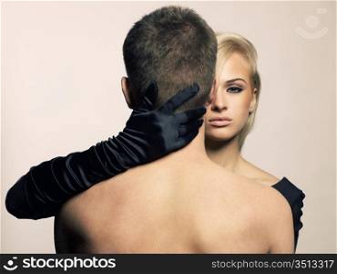 Beautiful passionate girl hugging a man by the neck