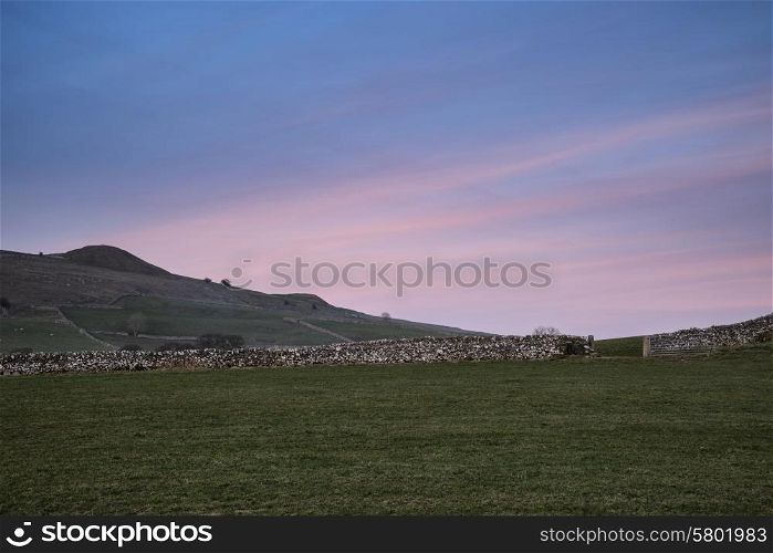 Beautiful pastel sunset over Peak District landscape in UK in Spring