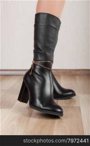 Beautiful patent leather boots with slender legs