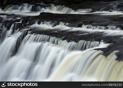 Beautiful peaceful landscape image of Aysgarth Falls in Yorkshire Dales in England during Winter morning