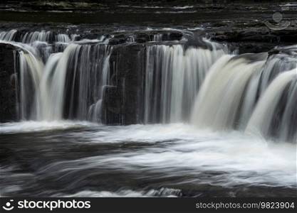 Beautiful peaceful landscape image of Aysgarth Falls in Yorkshire Dales in England during Winter morning