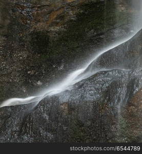 Beautiful peaceful long exposure waterfall detail intimate lands. Stunning peaceful long exposure waterfall detail intimate landscape image