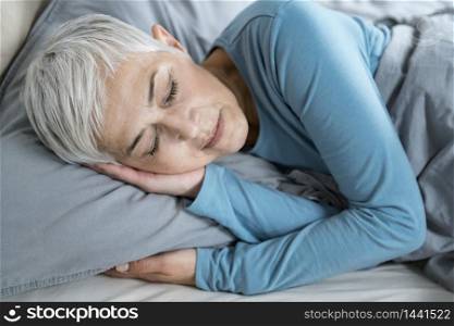 Beautiful Peaceful Mature Woman Sleeping in Bed