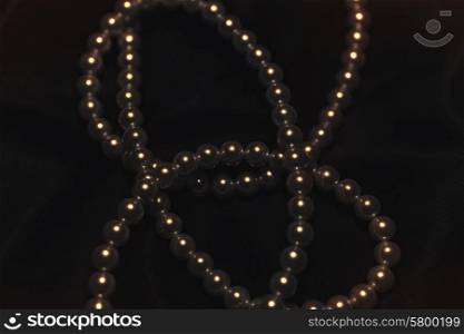 beautiful pearl necklace on a black silk close up