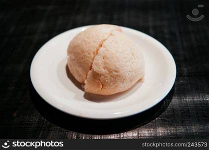 Beautiful peice of Japanese famous Melon bun cut into half on white plate of Hida Furukawa town, Gifu. Japan