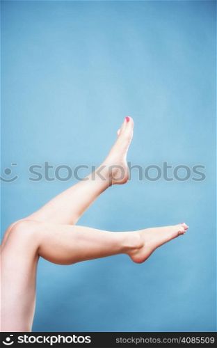 Beautiful perfect long naked woman girl legs barefoot body care pedicure on blue