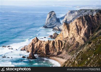 Beautiful photo depicting rocks, sea and vegetation. The place where the earth ends and the sea begins, Cabo da Roca Cape Roca , Sintra, Portugal. Beautiful photo depicting rocks, sea and vegetation