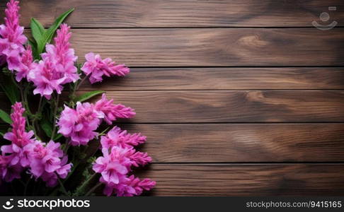 Beautiful pink flowers on wooden background. Top view with copy space