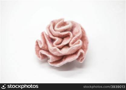 Beautiful pink rose flower milled wool on a white background.. Beautiful pink rose flower milled wool on a white background