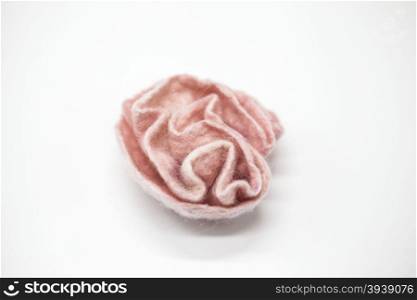 Beautiful pink rose flower milled wool on a white background.. Beautiful pink rose flower milled wool on a white background