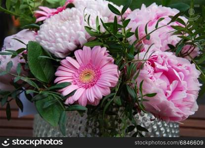 Beautiful pink summer flowers bouquet in a vase outdoors in a garden. Beautiful summer flowers