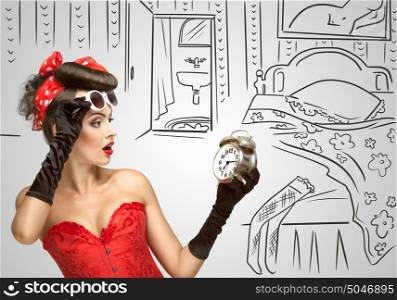 Beautiful pinup girl in a red vintage dress being late in the morning and holding a retro alarm clock in her hand on a sketchy background.