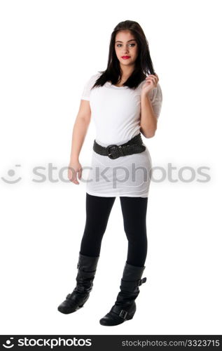 Beautiful playful brunette Caucasian Hispanic Latina woman with red lipstick standing touching her hair, wearing white shirt and black leggings, isolated.