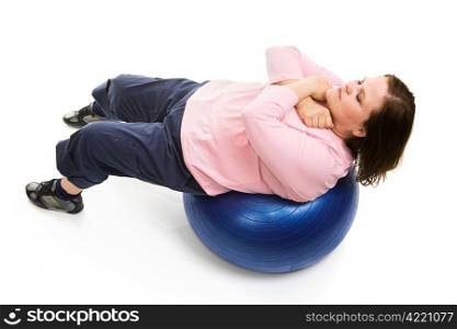 Beautiful plus-sized model doing crunches on a pilates ball. Full body isolated on white.