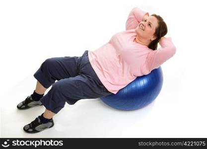 Beautiful plus sized model doing crunches on a pilates workout ball. Isolated on white.