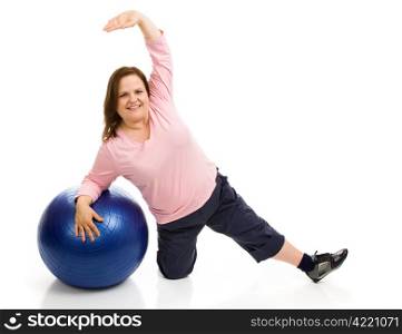 Beautiful plus sized model exercising with a pilates ball. Full body isolated on white.