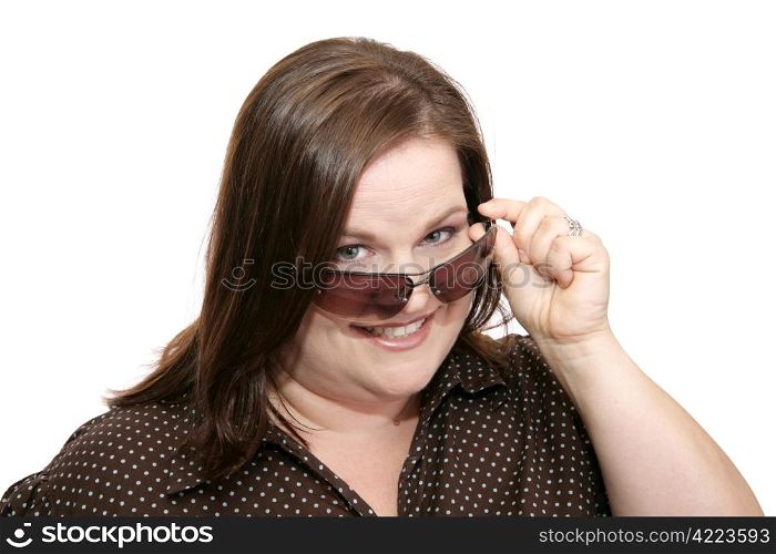 Beautiful plus sized model flirting by lowering her sunglasses to check you out. Isolated on white.
