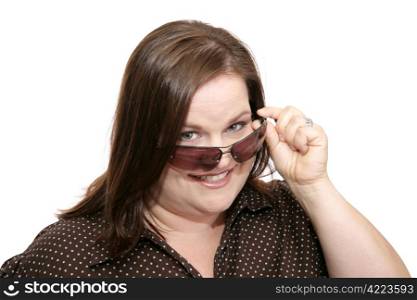 Beautiful plus sized model flirting by lowering her sunglasses to check you out. Isolated on white.