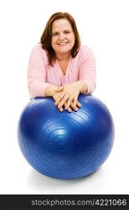 Beautiful plus sized model in workout clothes leaning on a pilates ball. Isolated on white.