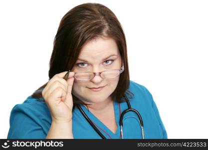 Beautiful plus sized nurse in scrubs with a no-nonsense expression. Isolated on white.