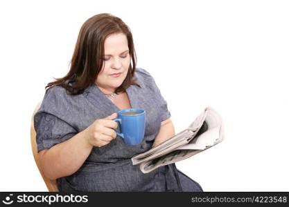 Beautiful plus-sized woman reading the newspaper and drinking coffee. Isolated on white.