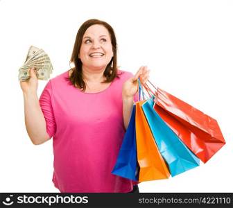 Beautiful plus sized woman with a hand full of cash and shopping bags, wondering what to buy next. Isolated on white.