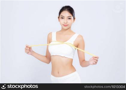 Beautiful portrait asian woman diet and slim with measuring breast and augmentation isolated on white background, girl have cellulite loss with tape measure, health and wellness concept.