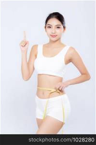 Beautiful portrait asian woman diet and slim with measuring waist for weight finger pointing something isolated on white background, girl have cellulite loss with tape measure, health and wellness concept.