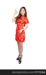 Beautiful portrait happy Chinese New Year young asian woman wear cheongsam fashion smile and cheerful with gesture ok and greeting isolated on white background, festival and celebrate concept.