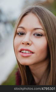 Beautiful portrait of a blonde girl with grass of background