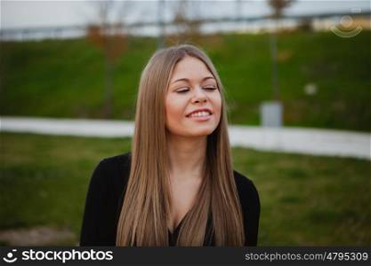 Beautiful portrait of a blonde girl with grass of background