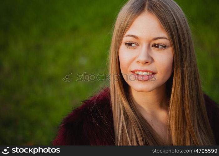 Beautiful portrait of a blonde girl with grass of background