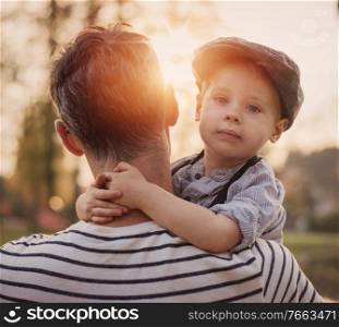 Beautiful portrait of a cute little boy hugging his father