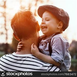 Beautiful portrait of a cute little boy hugging his father