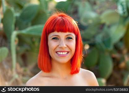 Beautiful portrait of a red hair girl in a park with cute shoulders