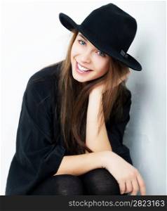 Beautiful portrait of smiling stylish young pretty woman in black fashion retro hat