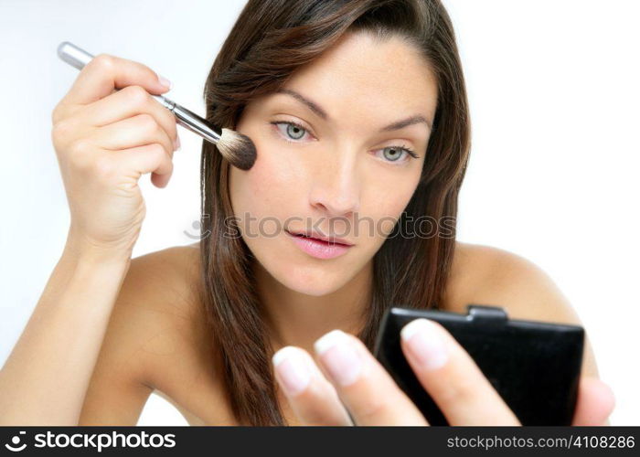 Beautiful portrait of woman makeup with brush over white