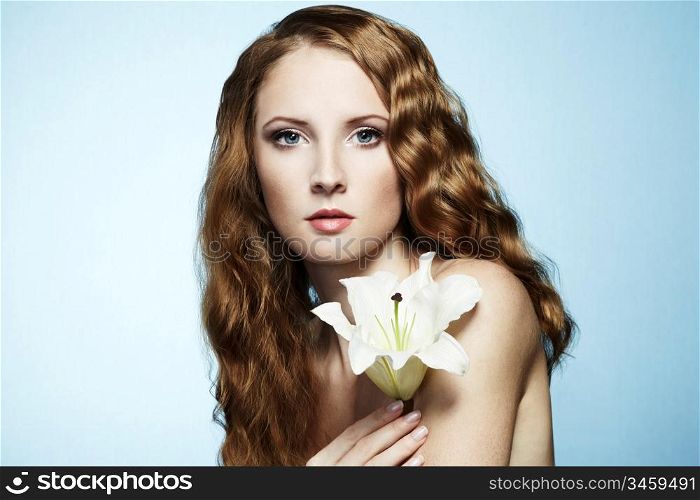 Beautiful portrait of young sensual woman with flower