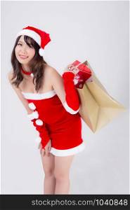 Beautiful portrait young asian woman happy and excited holding paper bag with gift box in xmas holiday isolated on white background, girl shopping and surprise in festive Christmas and new year.