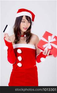 Beautiful portrait young asian woman happy holding credit card and red gift box in Christmas holiday isolated on white background, beauty asia girl surprise shopping with credit card in xmas day.
