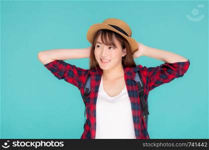 Beautiful portrait young asian woman holding hat smile expression confident enjoy summer holiday isolated blue background, model girl fashion having backpack, travel concept.