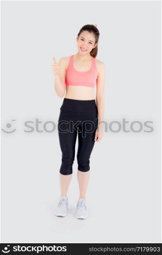 Beautiful portrait young asian woman in sport clothes with satisfied and confident gesture thumbs up isolated on white background, asia girl have shape and wellness, exercise for fit with health.