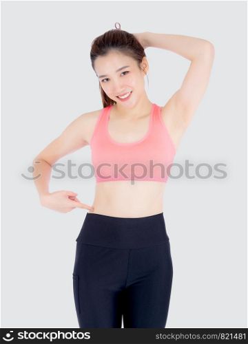 beautiful portrait young asian woman in sport clothing pointing waist with satisfied and confident isolated on white background, girl asia have shape and wellness, exercise for fit with health concept.