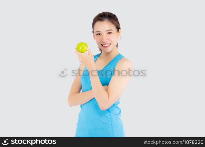 Beautiful portrait young asian woman in sport clothing with satisfied and holding green apple isolated on white background, girl asia have shape and wellness, exercise for fit with health concept.