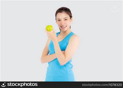 Beautiful portrait young asian woman in sport clothing with satisfied and holding green apple isolated on white background, girl asia have shape and wellness, exercise for fit with health concept.