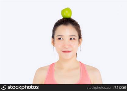Beautiful portrait young asian woman in sport with satisfied and green apple on head isolated on white background, girl asia have shape and wellness, exercise for fit with health concept.