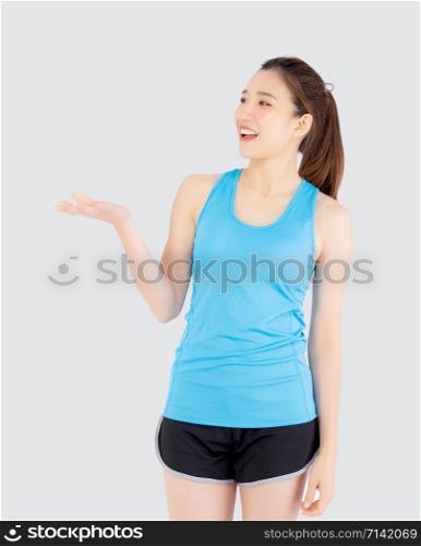 Beautiful portrait young asian woman in sport with satisfied and holding and throw green apple isolated on white background, girl asia have shape and wellness, exercise for fit with health concept.